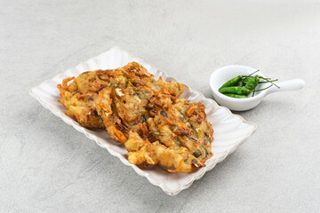 Bakwan sayur or bala-bala or vegetable fritter, Indonesian snack made from flour, cabbage, carrots and bean sprouts, served with chili or chili sauce. 
