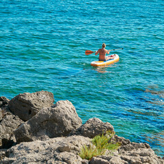 Woman on a stand up paddle board on the Adriatic Sea near Krk in Croatia