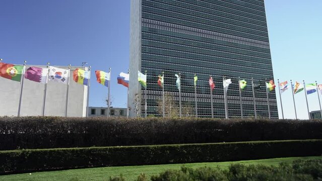 United Nations flags in front of UN Building in Manhattan. Slow motion flags flying in the wind