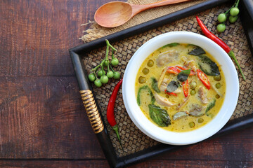 Thai Green curry with chicken  - Thai authentic food called  Kiew Wan with some ingredients served in bamboo tray with copy space