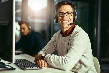 Were on standby and ready to take your call. Portrait of a young call centre agent working in an...