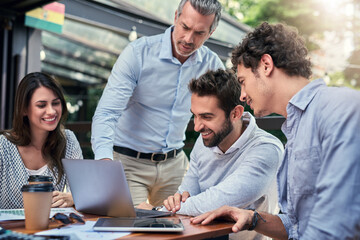 Getting down to business. Cropped shot of a group of business colleagues having a meeting outdoors at a cafe.