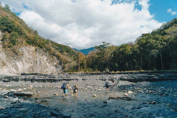 People hiking on the riverbank of the Wanda North Fork Hot Spring, Taiwan