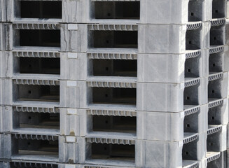 Stack of many plastic shipping pallets background in factory warehouse