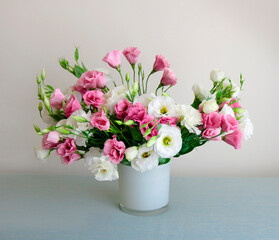 Bouquet of pink and white lisianthus flowers in vase, front view