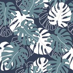 Seamless vector pattern with monstera leaves on blue background used for wallpaper and prints.