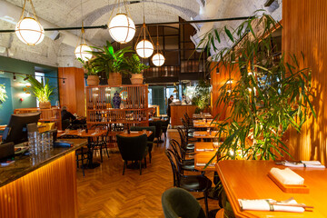 Interior of modern loft style restaurant. Bar counter. Interior porch with fresh flowers