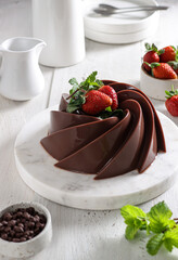 Puding Coklat. Chocolate puddings are a class of desserts with chocolate flavors topping with strawberry.