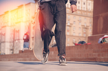 Skateboarder guy is getting ready for trick on skateboard with sunlight