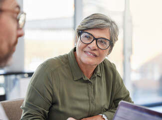 I love your energy. Shot of a mature businesswoman having a meeting with her colleague.