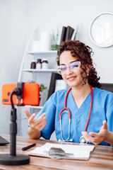 influencer female doctor using her phone making a video, social media and trends concept.