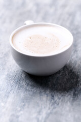 Coffee with milk on wooden background. Close up. Copy space.