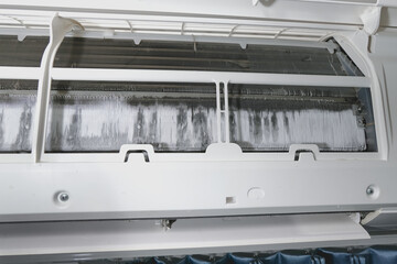 Air conditioner maintenance. Ice on air conditioner.  Service air conditioner. fin of the cooling...