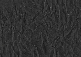 Black paper wrinkled texture background.