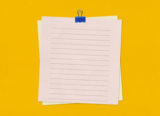 Empty note paper with clip on yellow art paper background. - 497419894