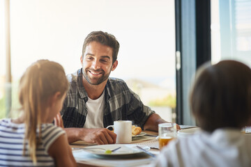 Theyve got plenty of stories to share with Dad. Shot of a father having breakfast with his children at home.