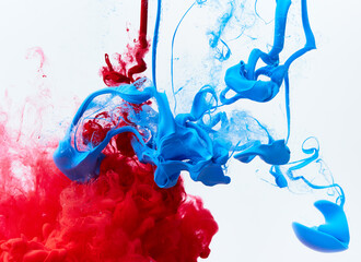 Blue and red paint splash in water on gray. Acrylic blue ink drop background. Abstract colors swirl texture