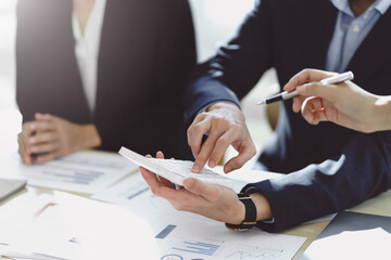 Business people using a calculator Think analyzing income, financial statements, balance sheet, company information.