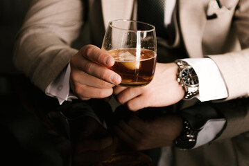 Men's hands with glasses of whiskey barbershop