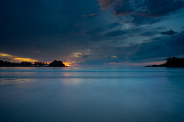 Naklejka na ściany i meble Sunset on the beach on a cloudy day, Ko Pra Thong, Thailand