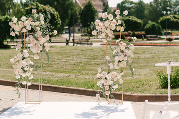 Wedding flower arch for the exit ceremony of marriage registration in the form of two racks with...