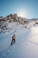 Mountaineer backcountry ski walking ski alpinist in the mountains. Ski touring in alpine landscape...