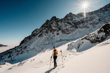 Mountaineer backcountry ski walking ski alpinist in the mountains. Ski touring in alpine landscape...