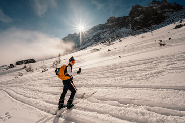 Mountaineer backcountry ski walking ski alpinist in the mountains. Ski touring in alpine landscape...