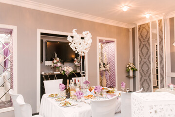 Hall decor for events, wedding decor, presidium and tables for guests with flowers, table decor elements