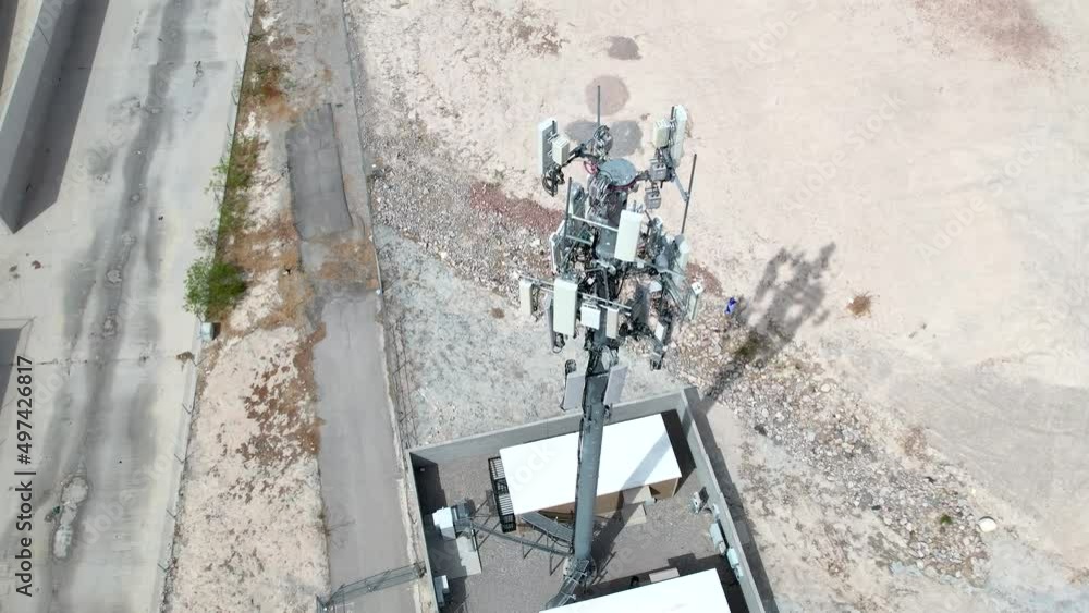 Poster a cellular communications tower - isolated view as seen descending and tilt up from a drone