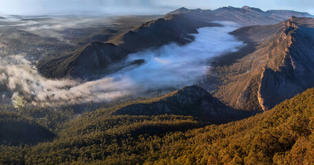 Mountain ranges aerial view from above with mist early morning