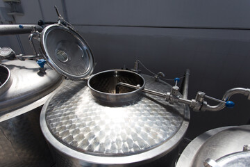 Close up on beer brewery tools inside a brewing facility, no people are visible.