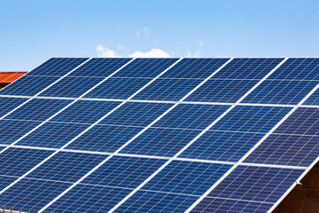 Solar panels on the roof of a house close-up. The solar panels are stacked close to each other.