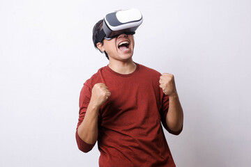 Asian man in casual style using Virtual Reality glasses feeling surprised and amazed, studio shot, mock up branding and copy space for creative advertisement designer 