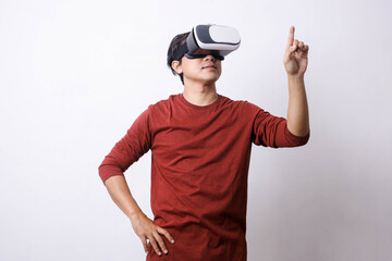 Fototapeta na wymiar Asian man in casual style using Virtual Reality glasses make movement, studio shot, mock up branding and copy space for creative advertisement designer