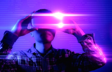 Fototapeta na wymiar Asian man wearing virtual reality goggles, Future technology concept.
