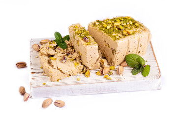 Sesame halva with pistachios on grey background. Top view. Copy space. Traditional middle eastern...