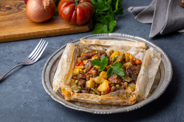 Traditional Turkish food; Meat with vegetables wrapped in greaseproof paper, kebab (Turkish name; Sebzeli kagit kebabi)