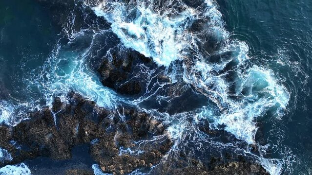 Aerial view of waves and clifs. Sea waves breaking over rocks, aerial view of drone