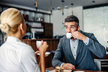 Couple having coffee and dessert in a coffee shop.