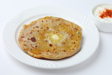 Traditional Indian food Aloo paratha or potato stuffed flat bread. served with curd