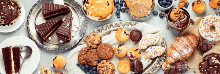 Dessert table with all kinds snacks on light background.