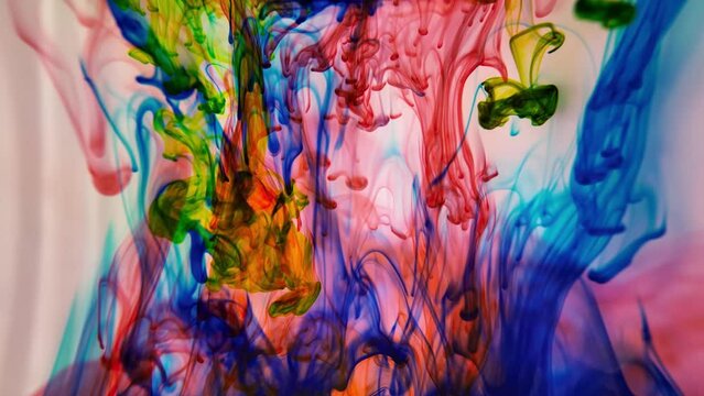 Colored splashes in abstract shape, color ink dropped. Acrylic colour paint in water. Art wallpaper with fluid smoke. Colorful splash. Creativity and art.