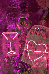 Disco ball and pink cages with neon light
