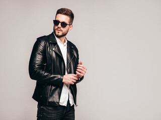 Portrait of handsome confident model. Sexy stylish man dressed in biker leather jacket and black...