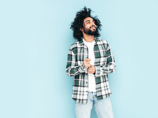 Handsome smiling hipster  model.Sexy unshaven Arabian man dressed in summer shirt and jeans...