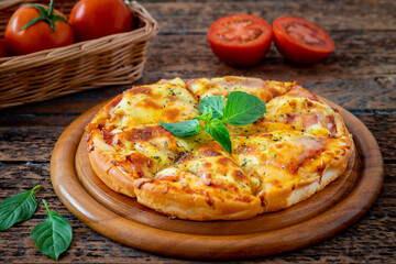 Pizza with bacon and mozzarella cheese on wooden plate