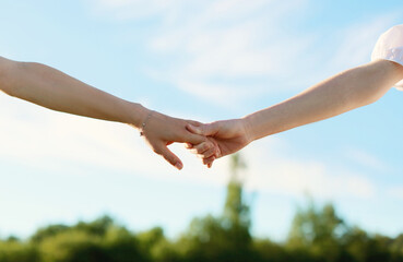 two hands holding each other