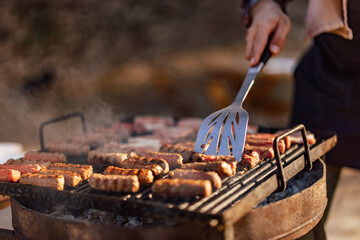 Close-up of a male doing barbecue, grilled meat.
