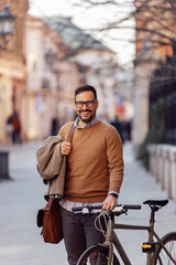 Fototapeta na wymiar Portrait of cheerful caucasian man, riding a bike, thinking about the environment.